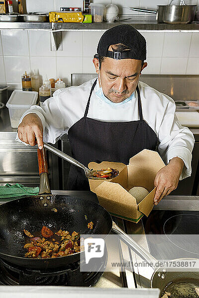 Chef preparing food parcel in restaurant kitchen