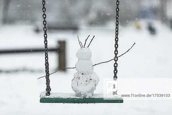Small snowman on chain swing