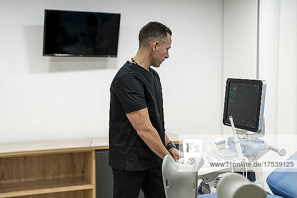 Gynecologist using medical scanner in hospital