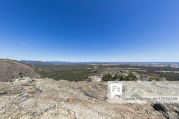 Australia  Victoria  Clear sky over female hiker ascending Hollow Mountain in Grampians National Park