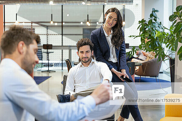 Businessman discussing with colleague at office