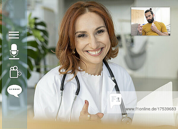 Smiling doctor consulting patient on video call