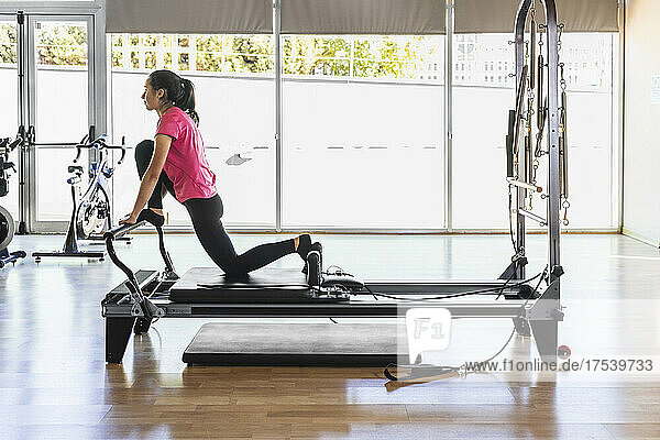 Athlete exercising on equipment at health club