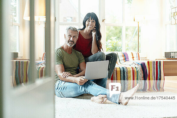 Mature couple with laptop at home