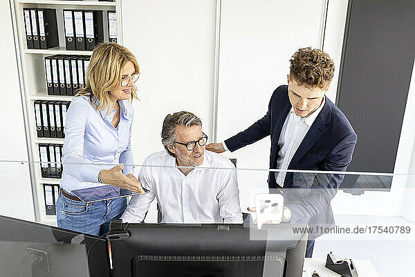 Businesswoman explaining colleague and trainee at office