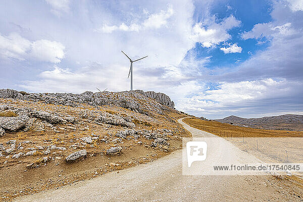 Empty road by wind turbine at Mirador Sierra Gorda in Andalucia  Spain  Europe