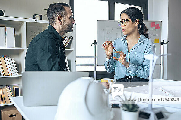 Businesswoman planning business strategy with architect in small office