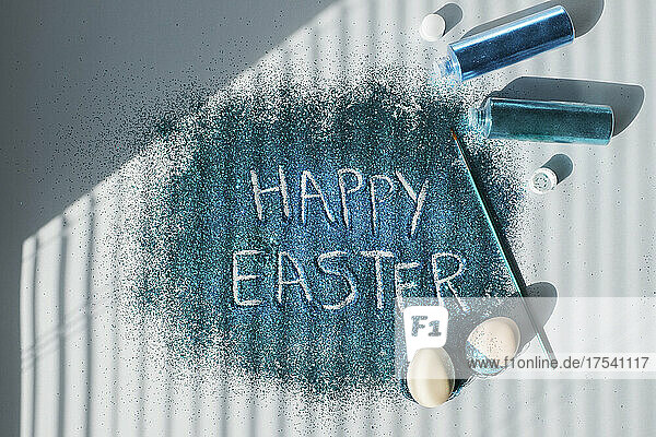 Happy Easter written in turquoise colored glitter