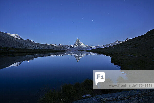 Reflection of Matterhorn mountain on Stellisee lake at night in Zermatt  Switzerland
