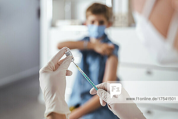 Nurse preparing injection at vaccination center