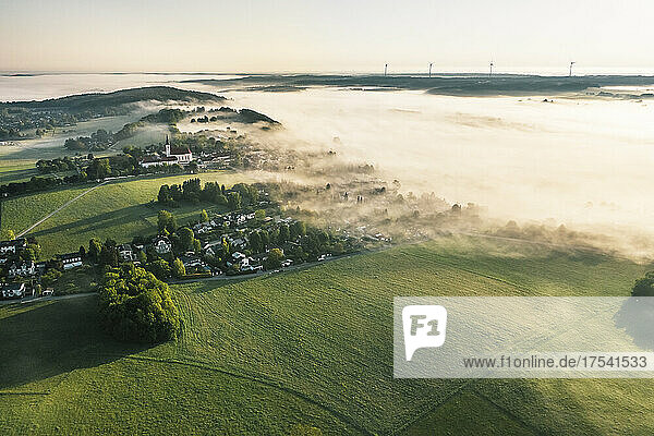 Germany  Bavaria  Berg  Aerial view of countryside village at foggy springtime dawn