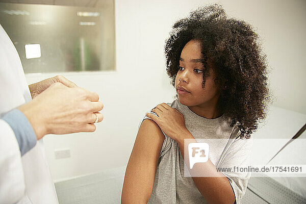 Girl looking at doctor in medical room