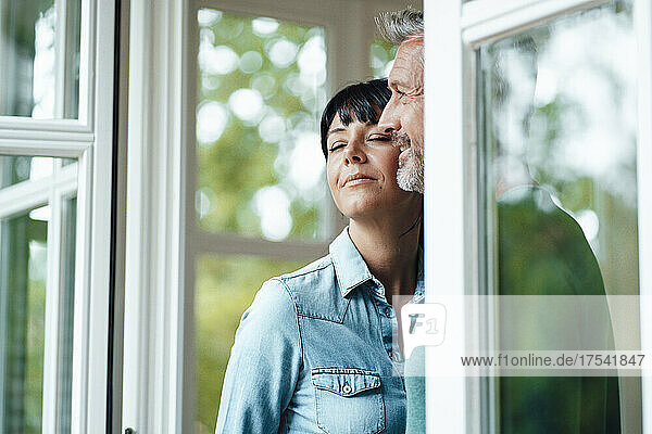 Thoughtful man with woman by window
