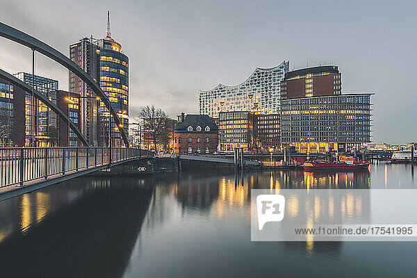Germany  Hamburg  Long exposure of HafenCity waterfront with Elbphilharmonie in background