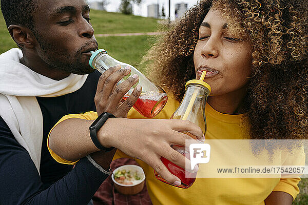 Friends drinking lemonade in park