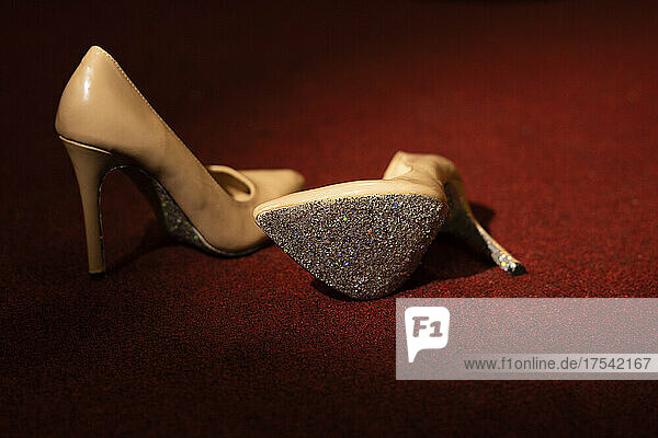 Shiny pair of high heels on red carpet