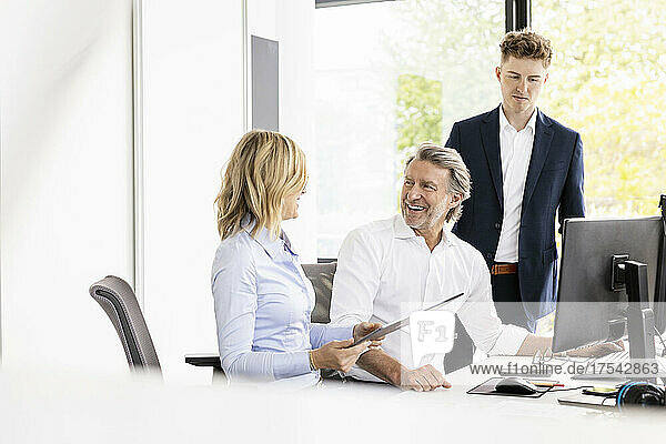 Businessman working with trainee and colleague at office