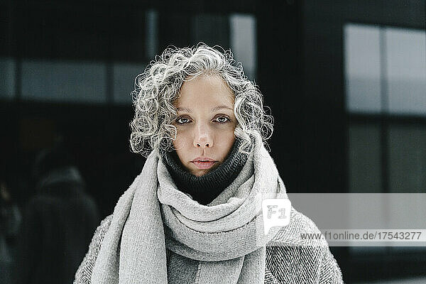 Woman with black expression wearing scarf
