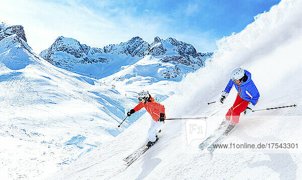 Man and woman skiing downhill on snowcapped mountain in Lech  Austria