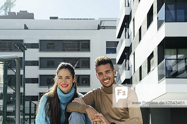 Happy couple in front of building
