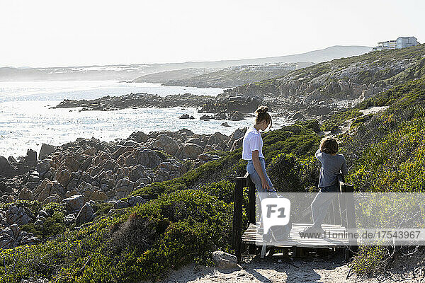 teenage girl and younger brother hiking the De Kelders coastal trail  South Africa