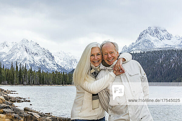 USA  Idaho  Stanley  Portrait of smiling senior couple at mountain lake