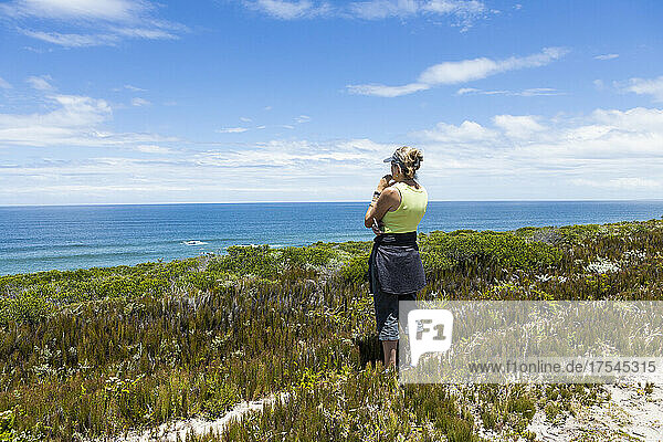 South Africa  Western Cape  Woman looking at ocean view in Lekkerwater Nature Reserve