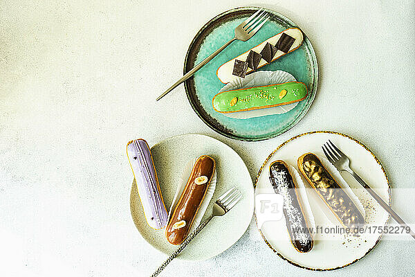 Variety of tasty french dessert eclair on the plates