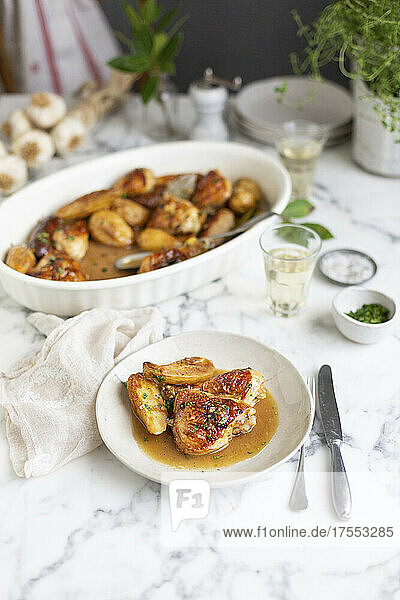 Chicken pieces roasted with potatoes and sausages