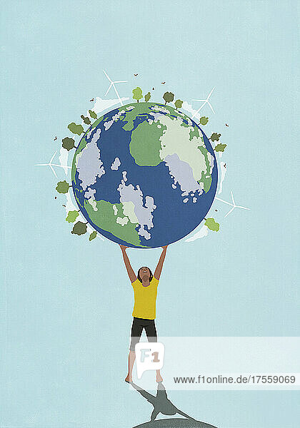 Entschlossene  ehrgeizige Frau hält Globus mit Windrädern und grünen Bäumen über sich