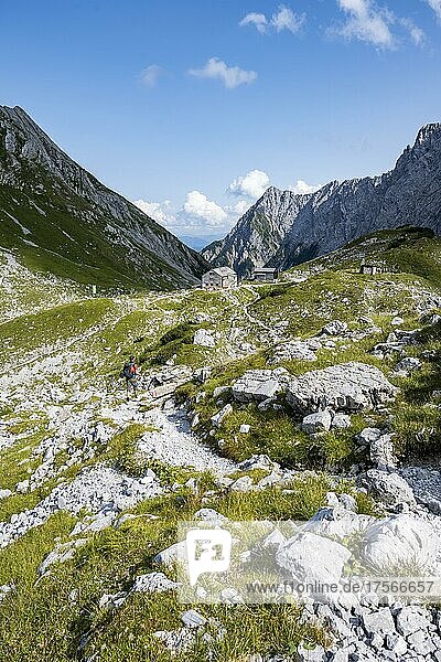 Hikers on a hiking trail  behind Lamsenjochhütte  Karwendel Mountains  Alpenpark Karwendel  Tyrol  Austria  Europe