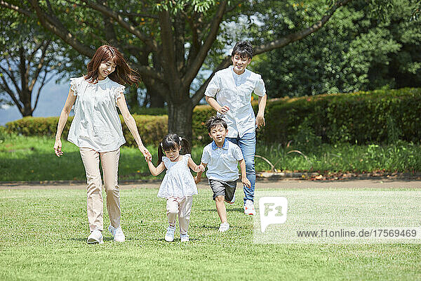 Japanese Family Taking A Walk In The Park