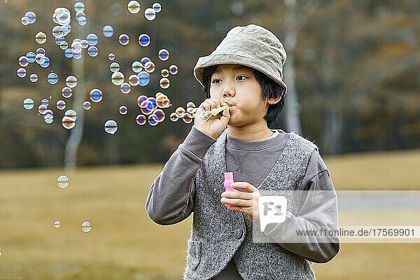 Japanese Boy Playing With Soap Bubbles