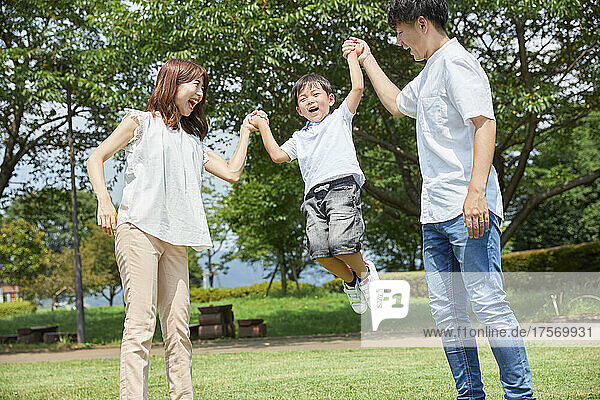 Japanese Boy Holding Hands And Jumping