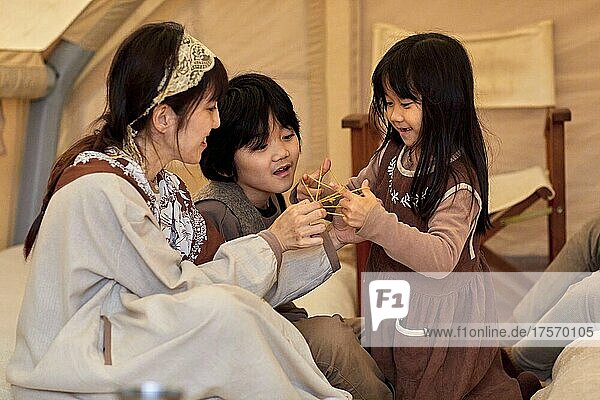 Japanese Family Enjoying Playing Ayatori