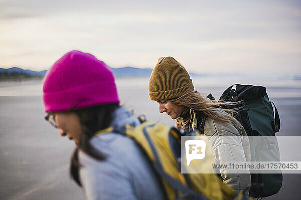 Pair of Millenial Woman on the beach at sunrise in Oregon