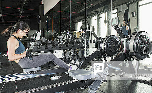 woman training with rowing machine at gym in Bangkok