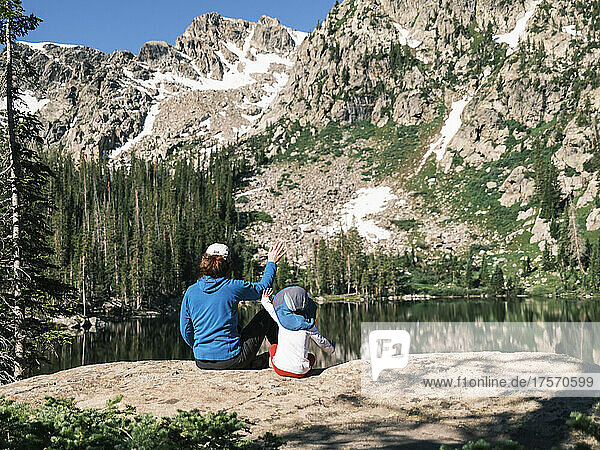 Mother and daughter waving to other hikers  Colorado