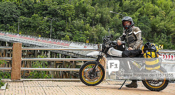 man posing on his motorbike in the North of Thailand
