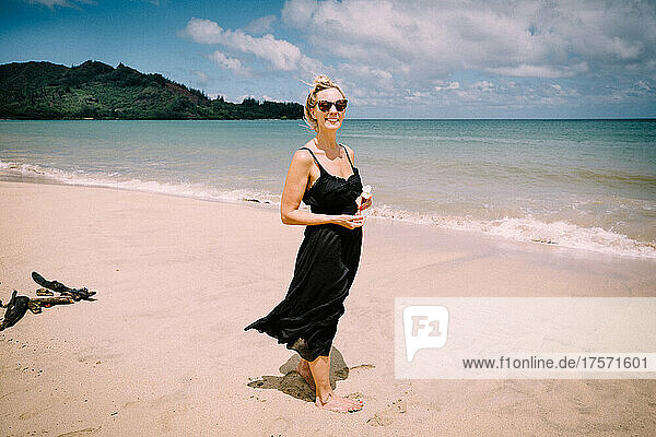 Blonde Woman Smiles with Joy on the Beach in Hanalei
