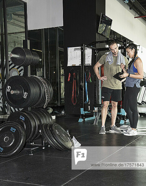 woman recording her progress at gym in Bangkok