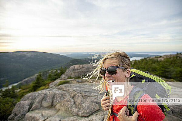 Smiling mid adult woman hikes in Acadia National Park  Maine