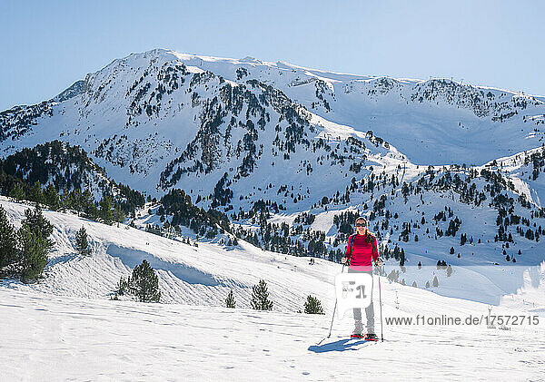Woman practicing winter sports. Snowshoeing on a sunny day