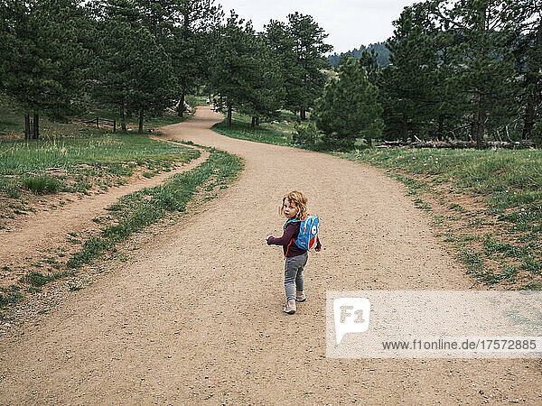Girl hiking with a backpack in Mount Falcon Park