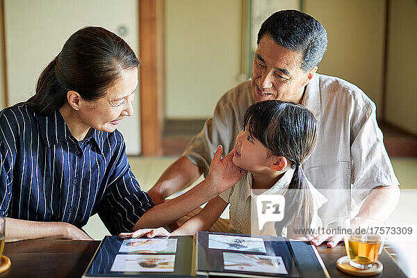 Smiling Grandchild And Japanese Senior Couple