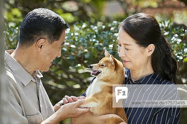 Japanese Senior Couple With Their Pet Dog