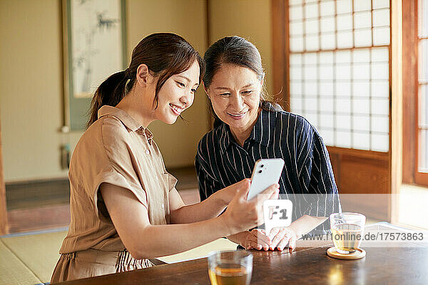 Japanese Senior Female Who Teaches Me How To Use Smartphone