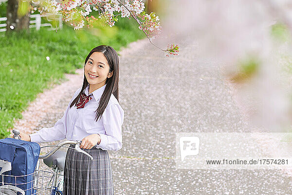 Japanese High School Girl Pushing A Bicycle