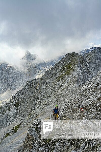 Hikers on trail to Lamsenspitze  rocky mountain peaks behind  Karwendel Mountains  Alpenpark Karwendel  Tyrol  Austria  Europe