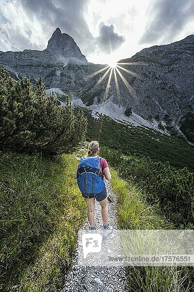 Sun star  hiker on the way to Lamsenspitze  Tyrol  Austria  Europe